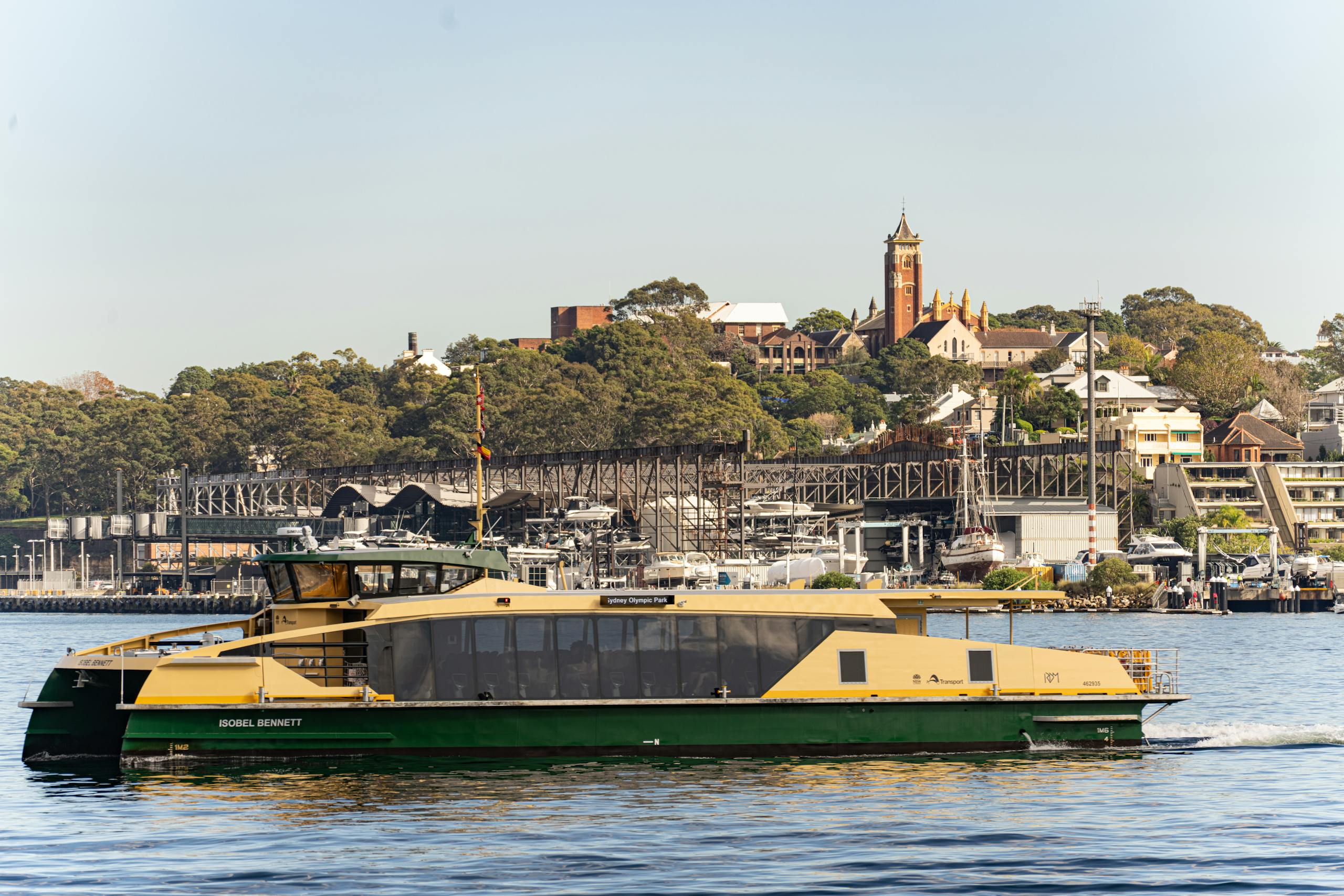 a ferry glides by barangaroo with cityscape and lush greenery in the background. 33364424 scaled