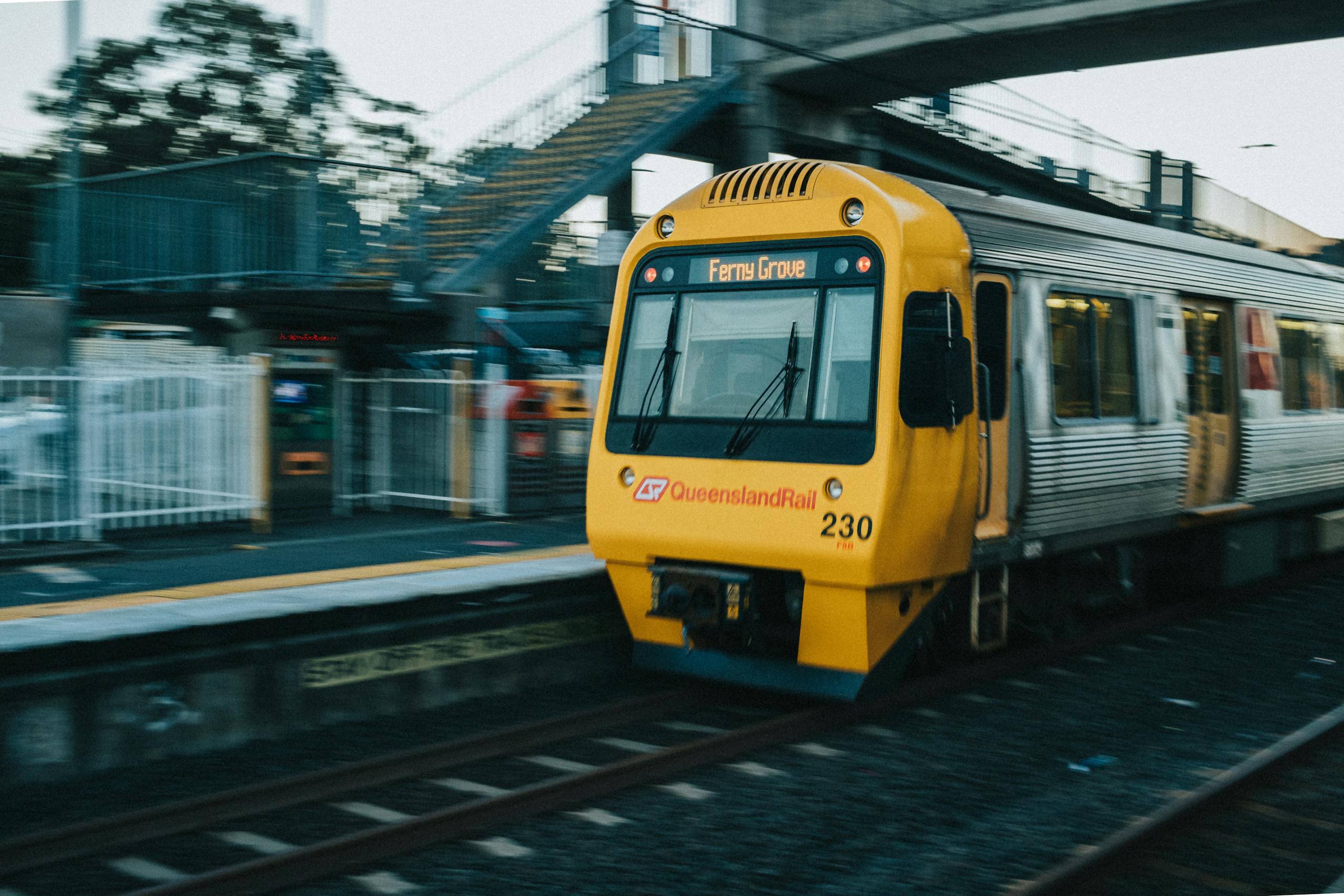a queensland rail train departs loganlea station in queensland australia captured in motion. 9993829 scaled