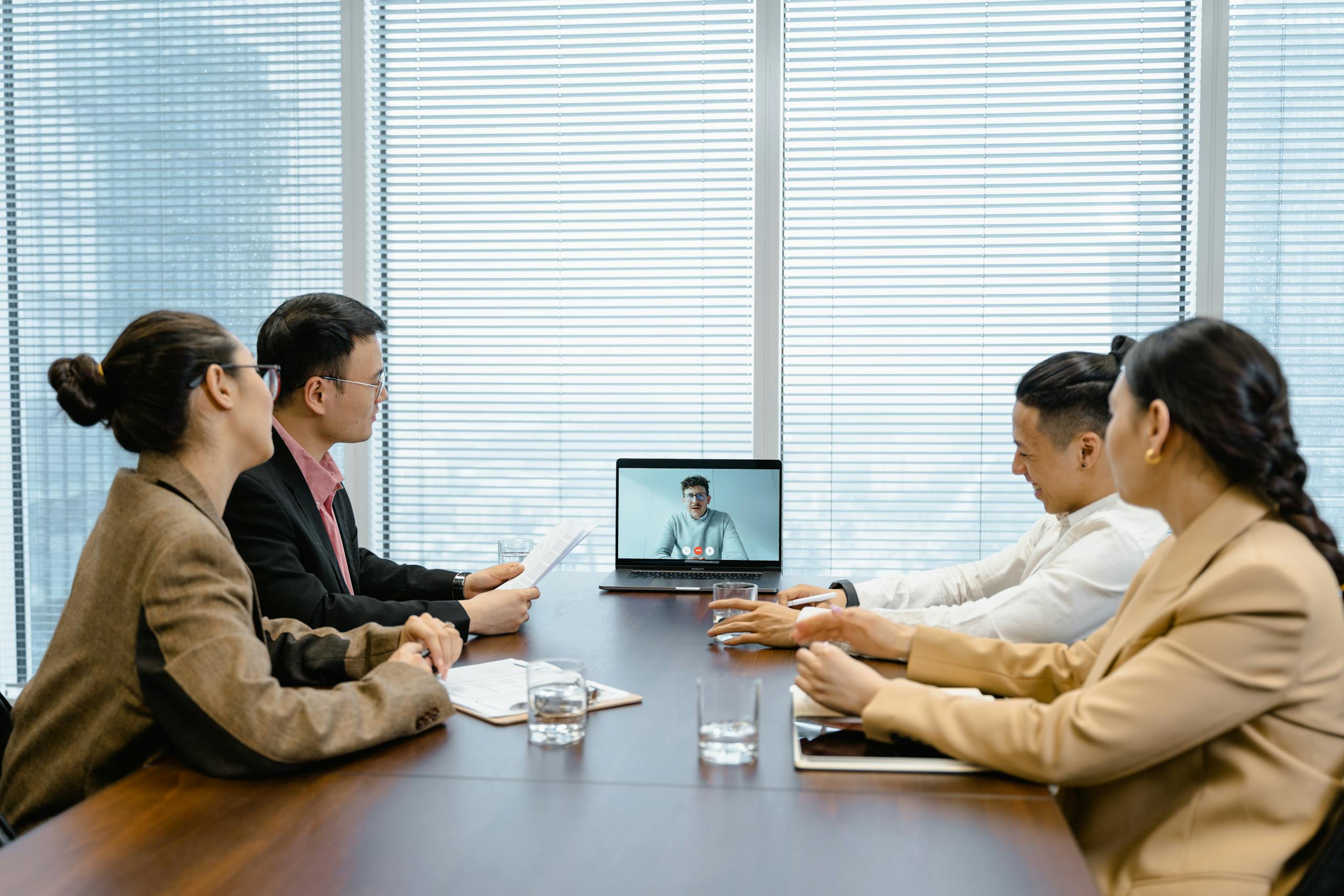 business meeting with video call setup highlighting teamwork and communication in a modern office environment. 7644076 scaled