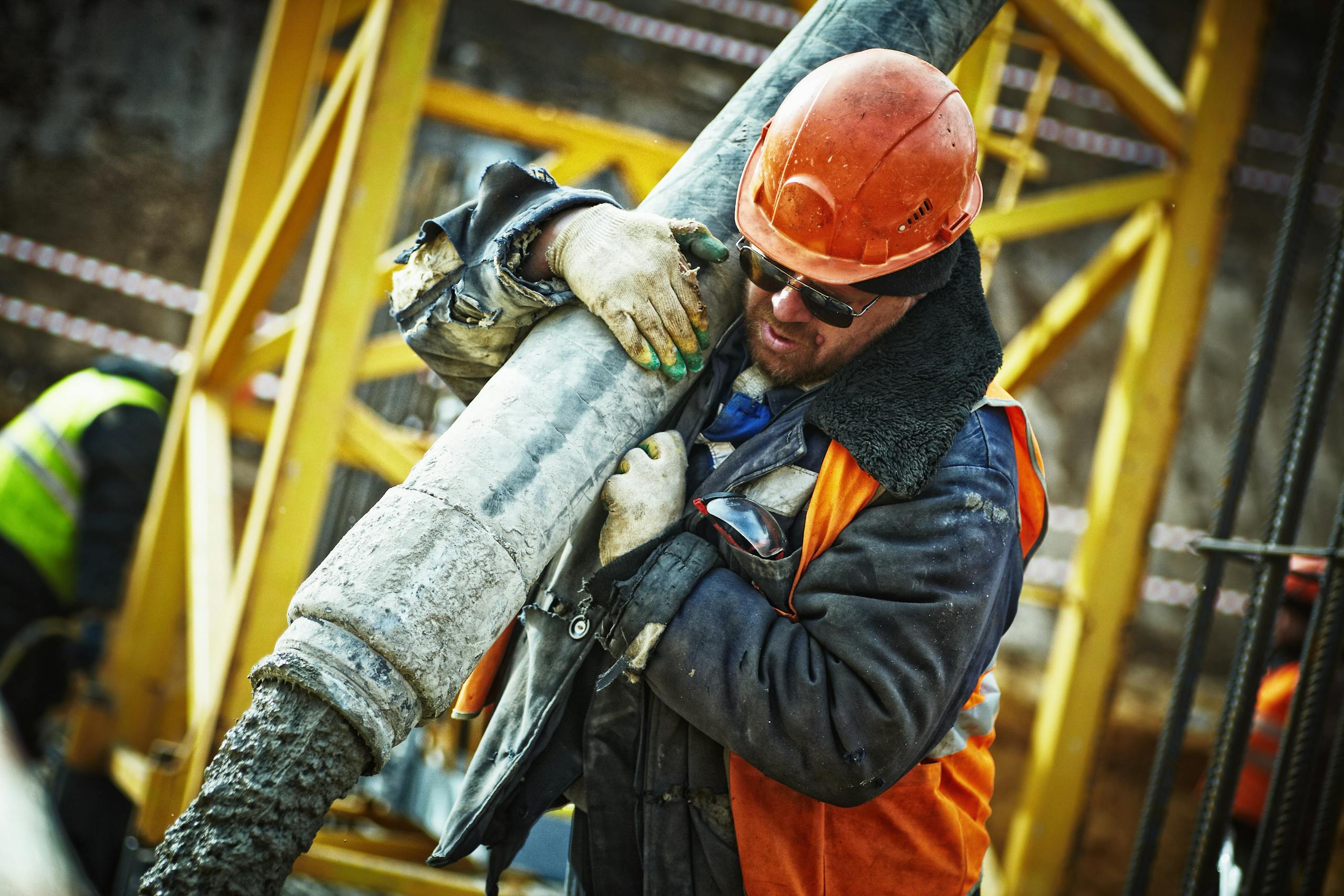 construction worker in safety gear handling equipment on an active site. 585419 scaled