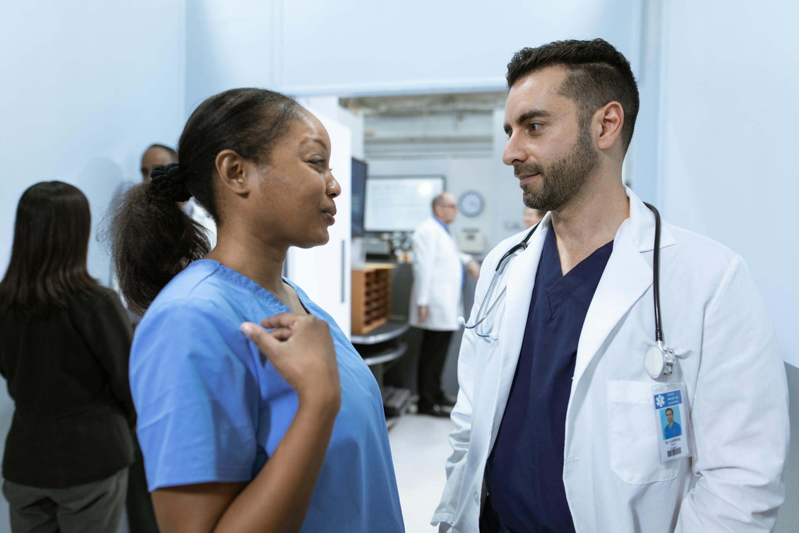 medical professionals discussing patient care in a hospital hallway. 6129657 scaled